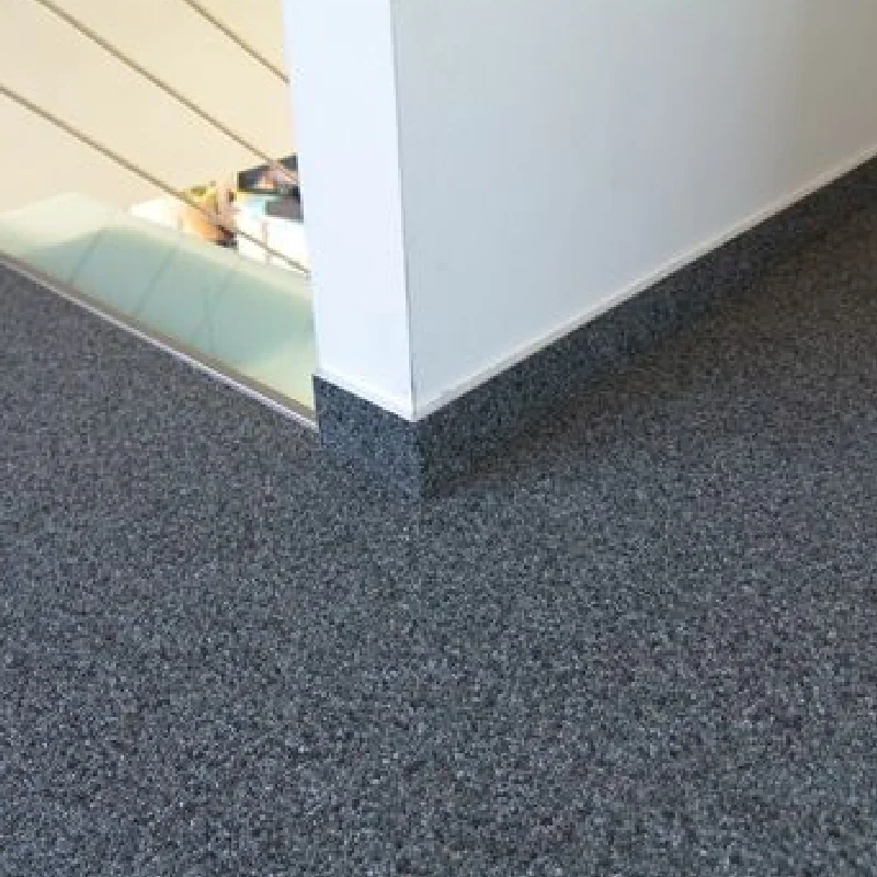 Dark gray stone carpet flooring in a modern home interior.