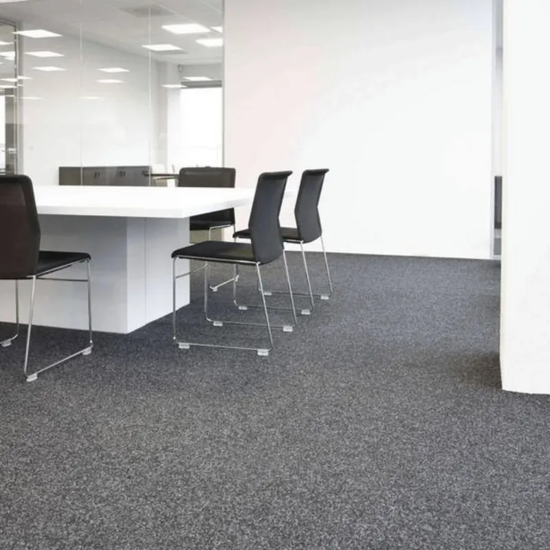 Office space featuring gray stone carpet flooring and modern furniture.