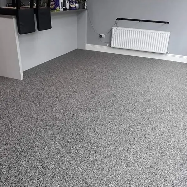Gray stone carpet flooring in a modern home interior.
